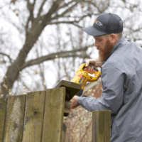 JUNKCO+ staff cutting down fence